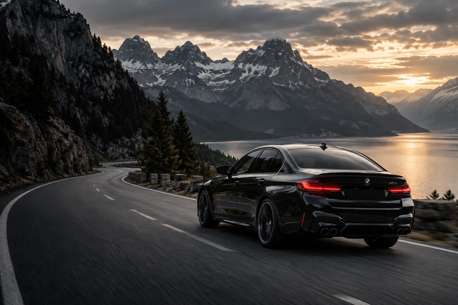 Black sport sedan on a scenic mountain road